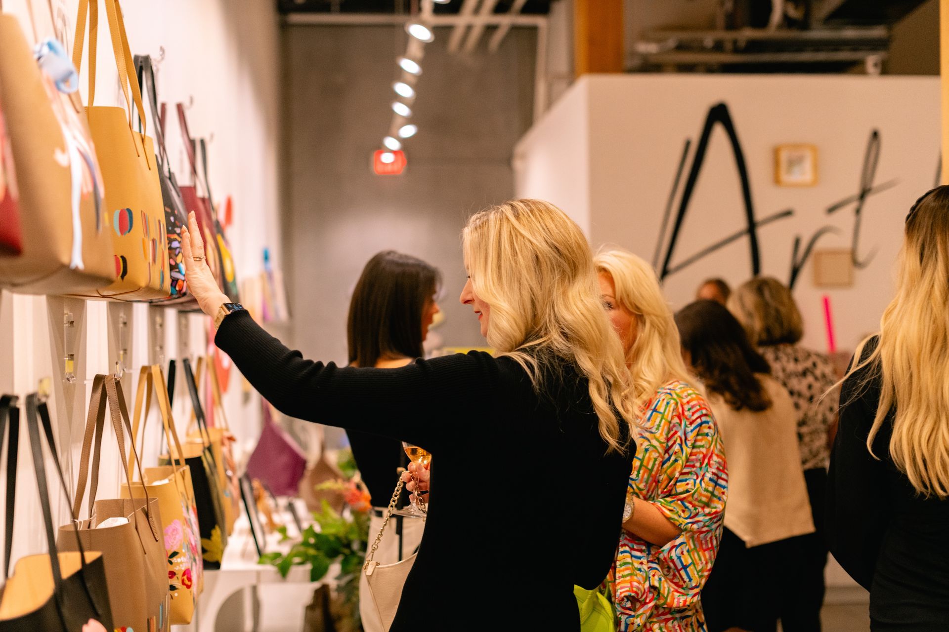 Leatherology's Executive Director, Laura Osier admiring the collection of bags