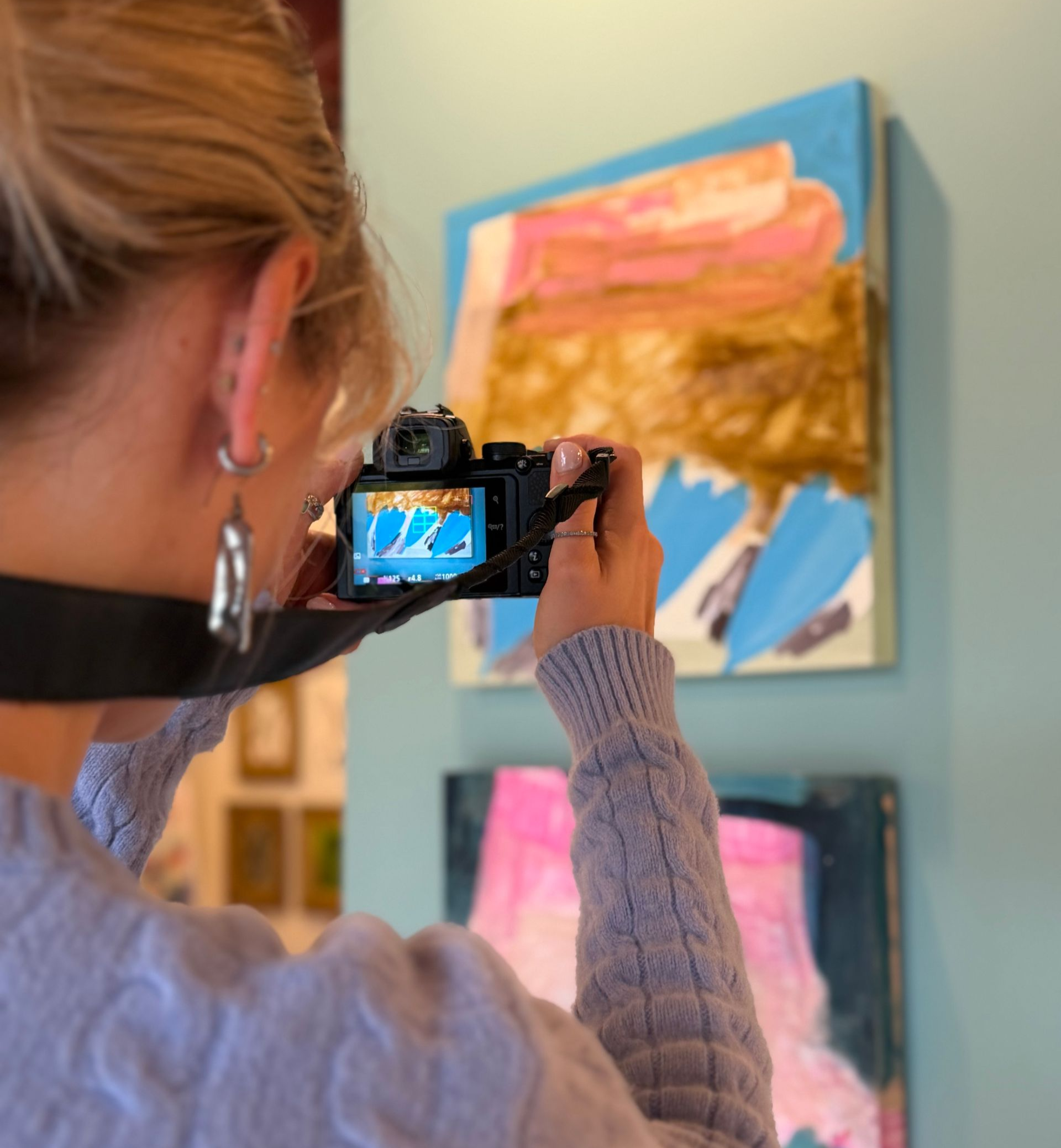 Lily taking photos of artwork