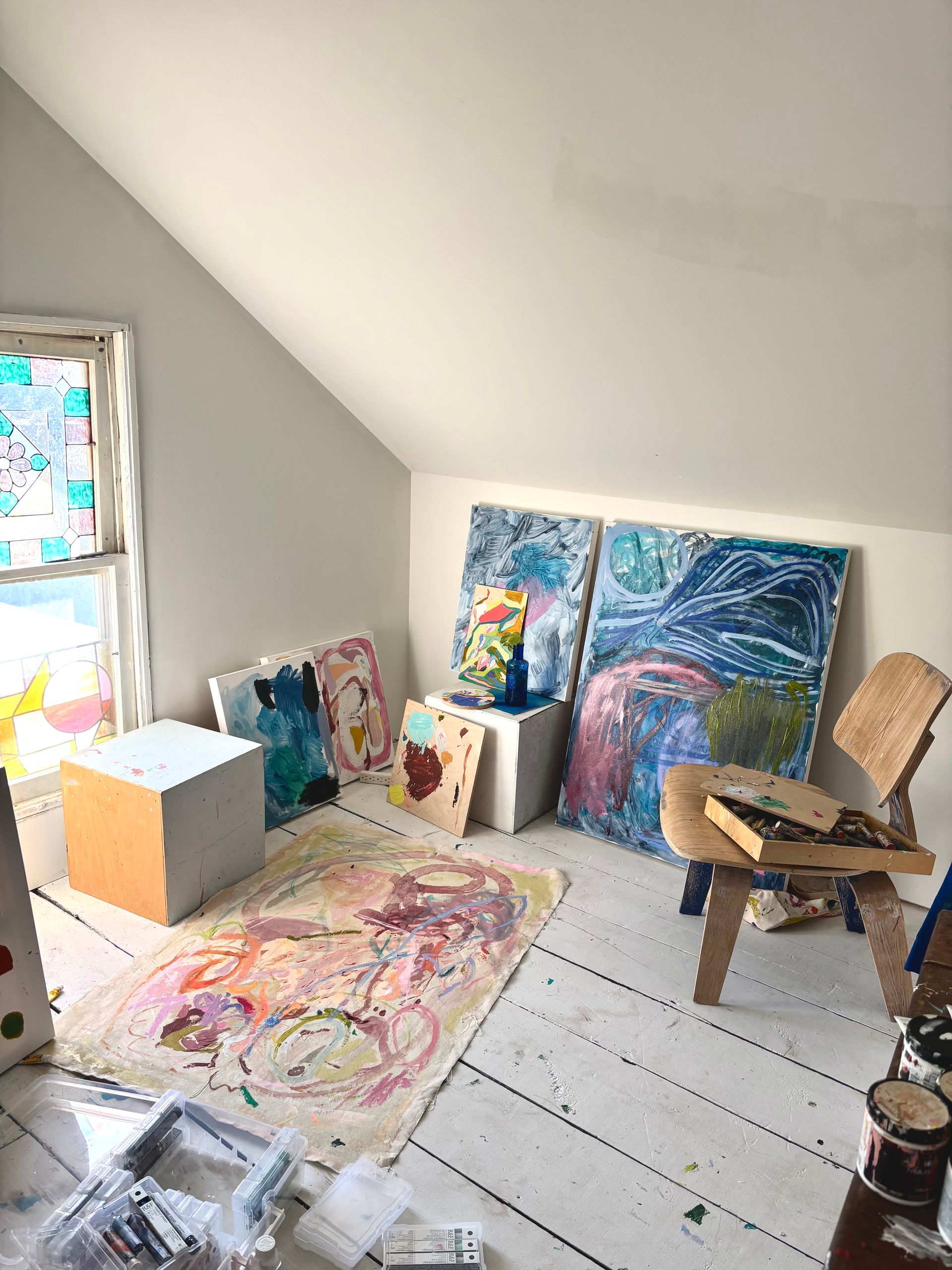 Ashley Mary’s studio staged with artwork and a chair