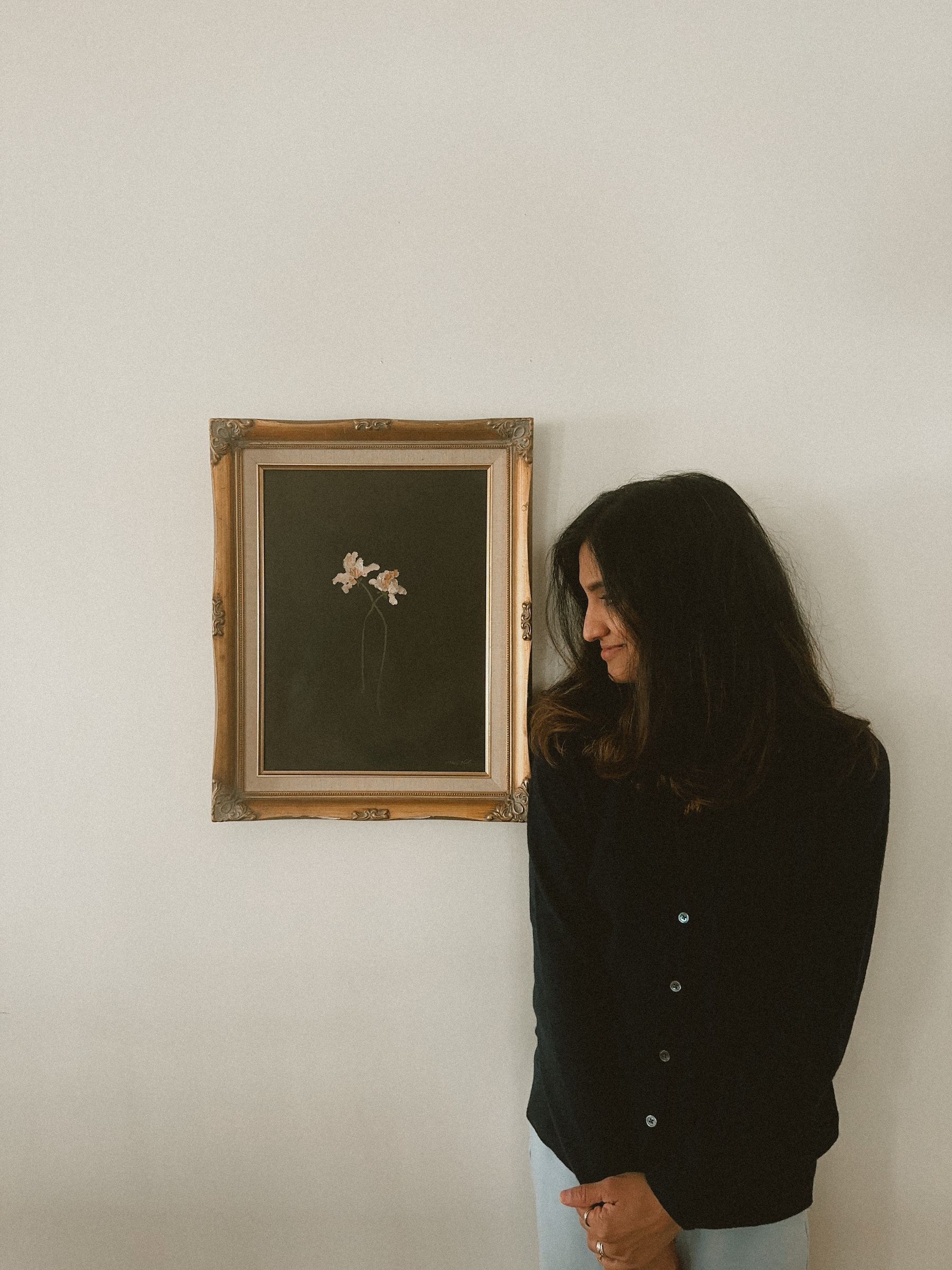 Anee Shah standing next to her painting