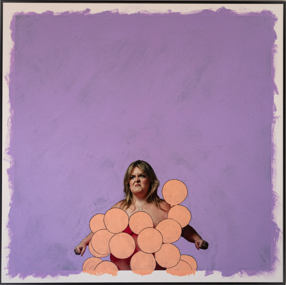 Woman dressed in balloons like a grape with purple background