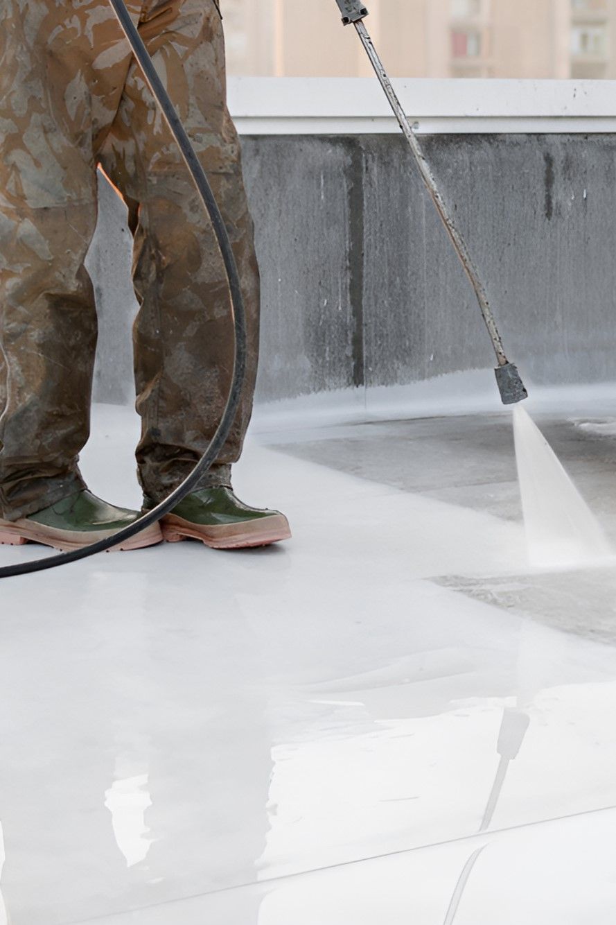 A Man is Using a High Pressure Washer to Clean a Roof — Sue's Clear Water in Koumala, QLD 