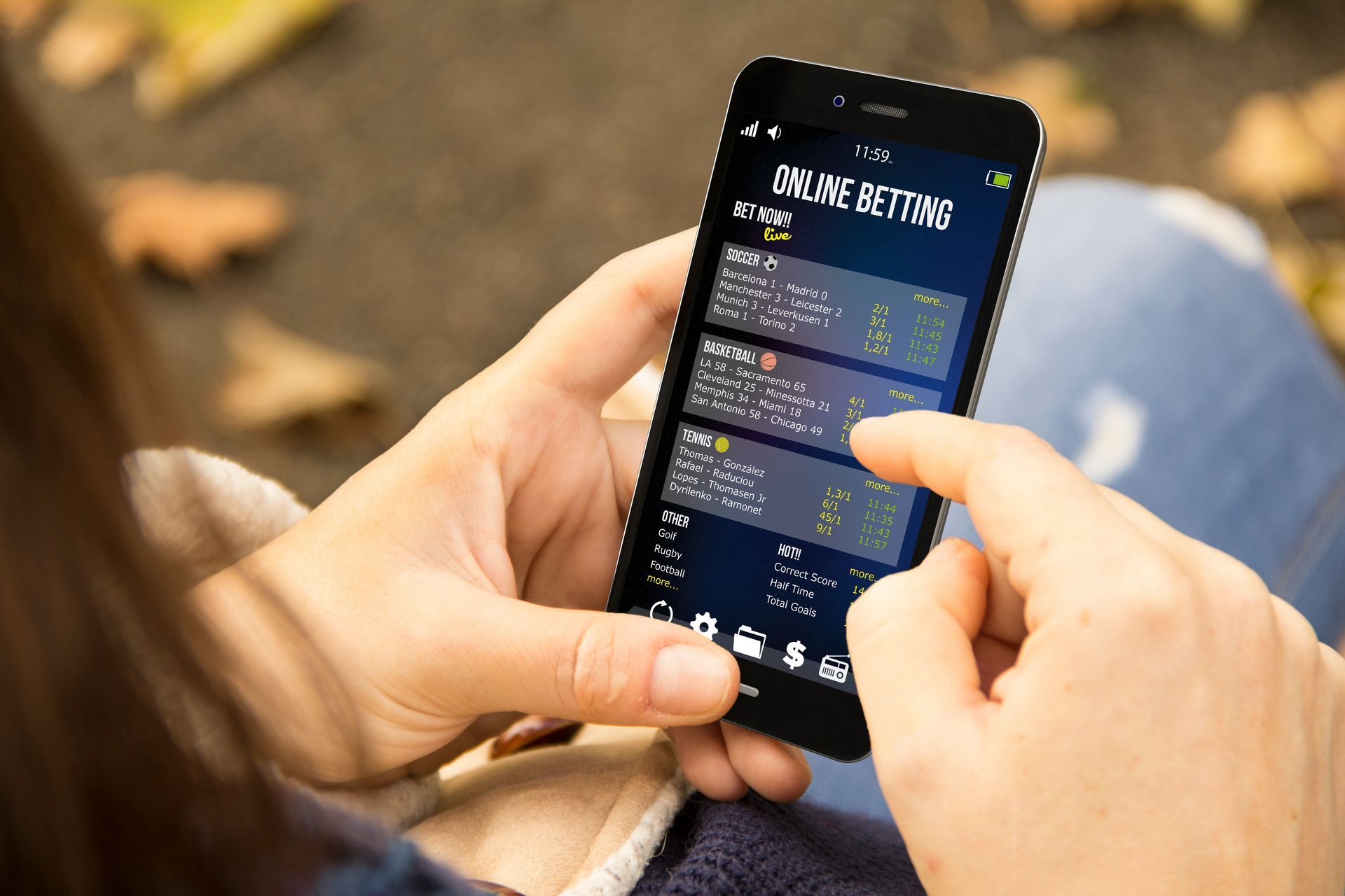 A person is holding a cell phone with a gambling app open.