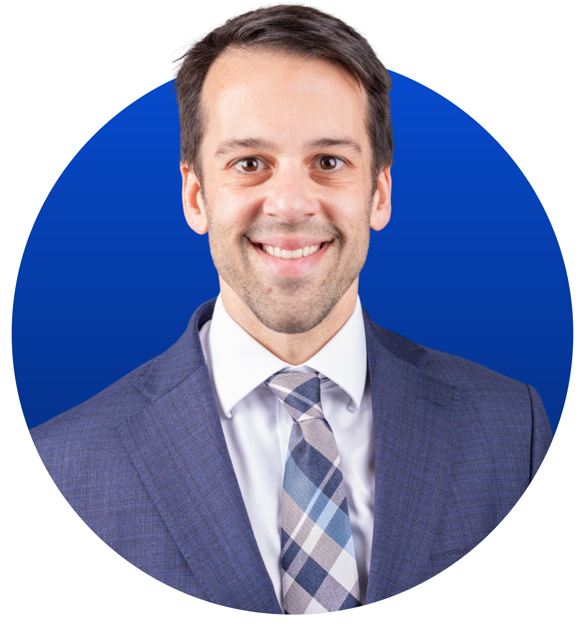 Man in suit smiling, blue background.