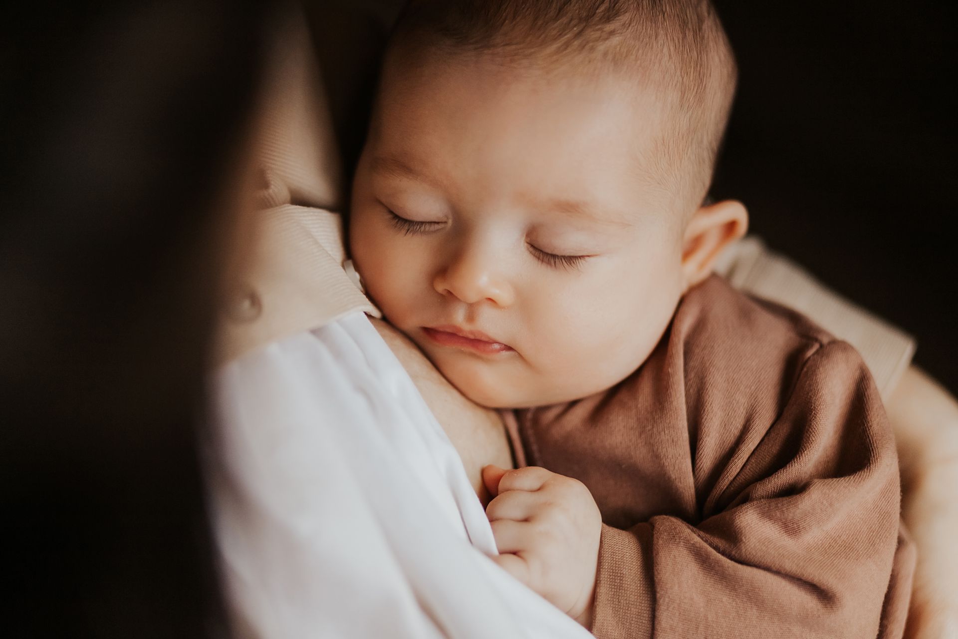 A picture of an injant being held by her mother. 