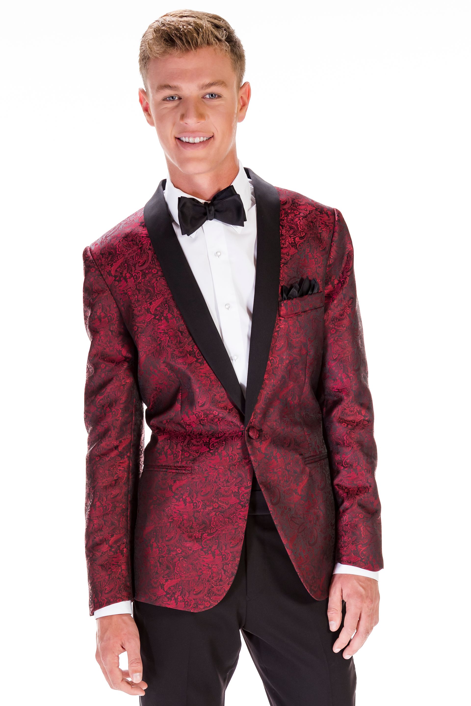 A young man is wearing a red tuxedo jacket and a black bow tie.