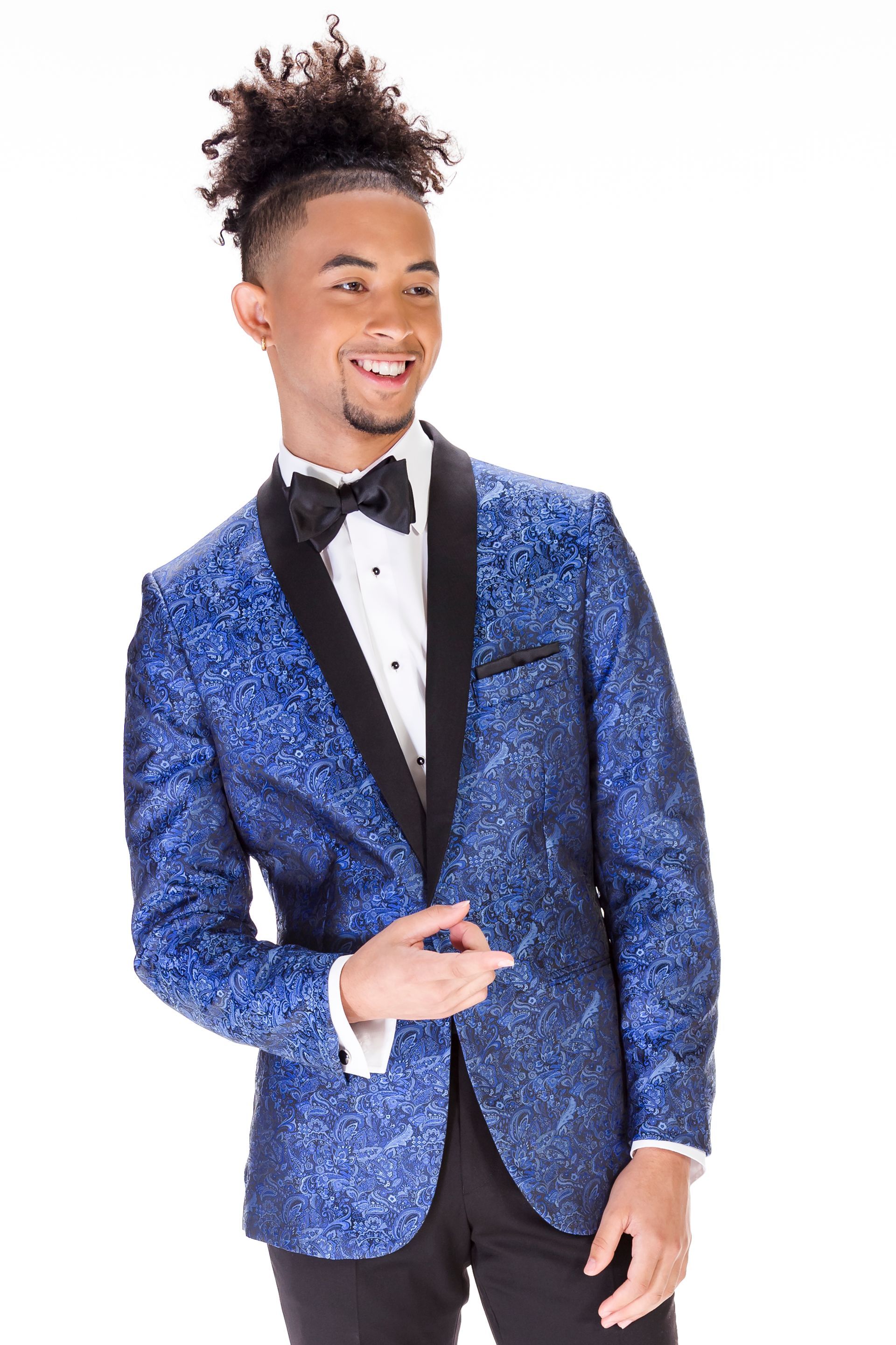 A young man is wearing a blue tuxedo jacket and bow tie.