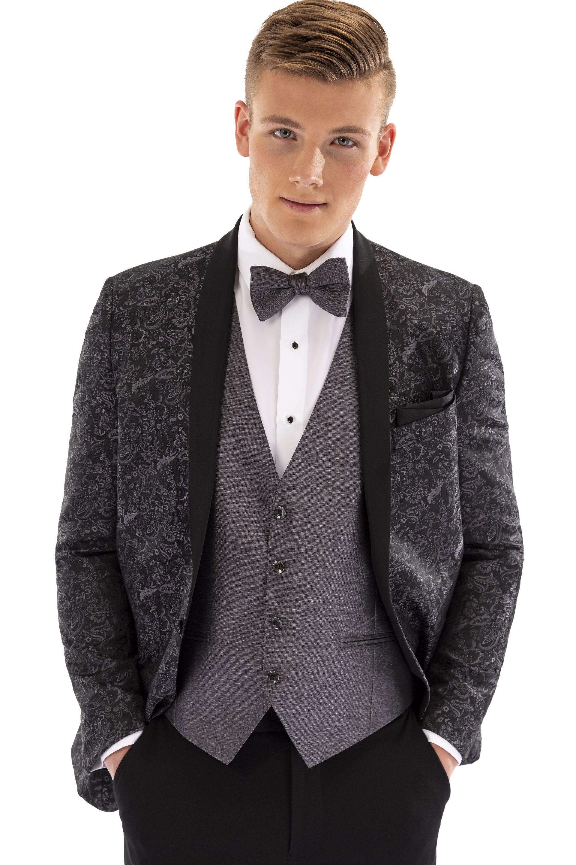 A young man is wearing a tuxedo and bow tie.