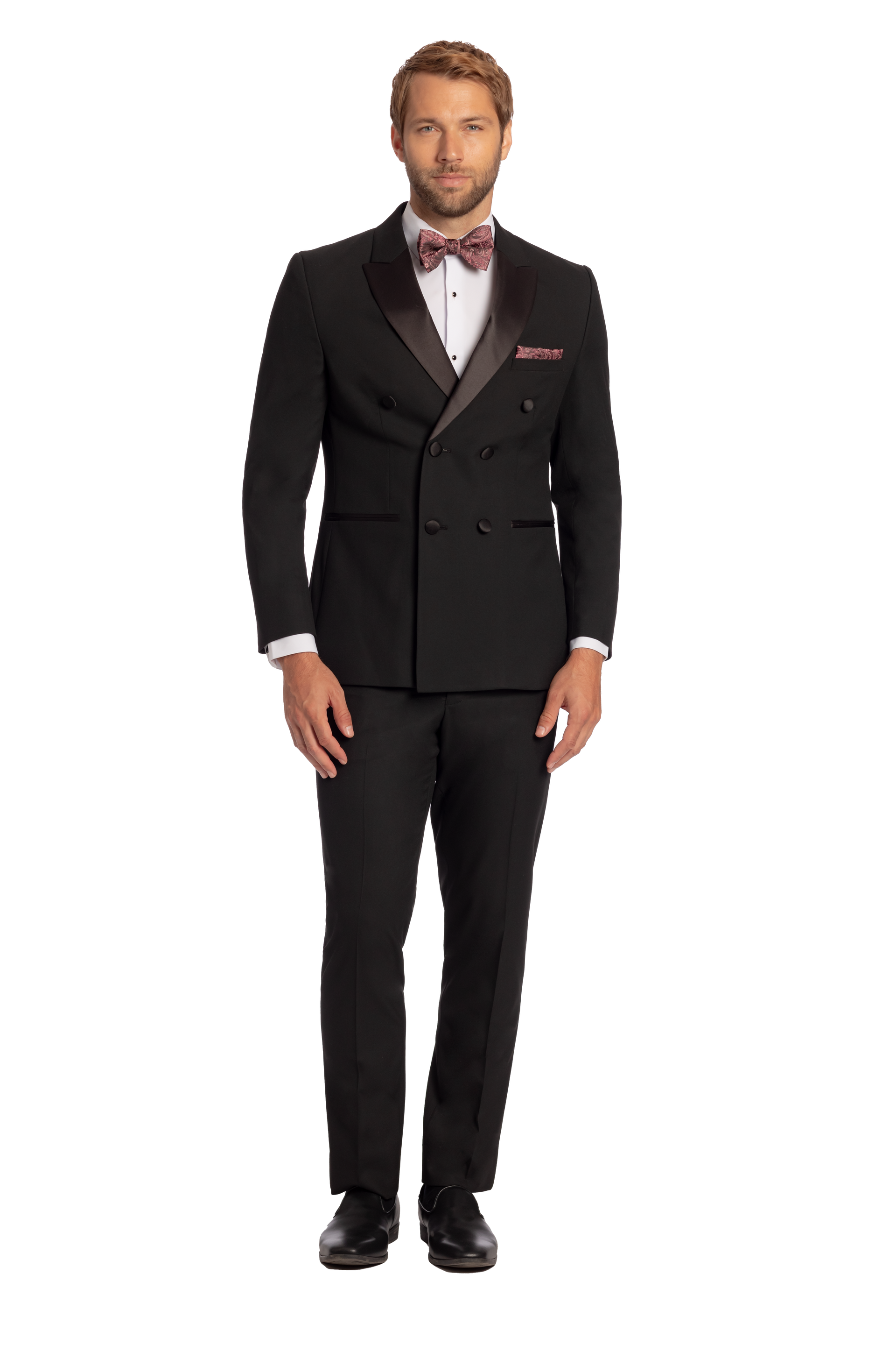 A man is wearing a black tuxedo and a bow tie.