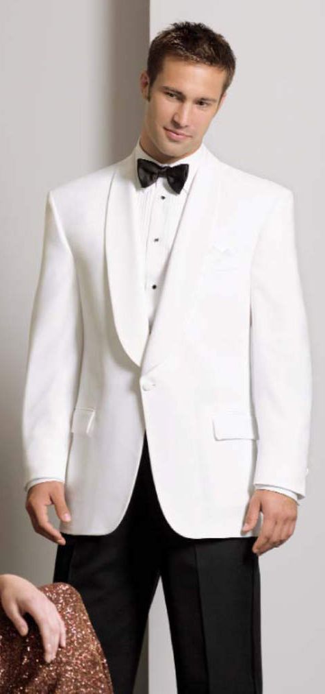 A man in a white tuxedo and black pants is standing next to a woman.