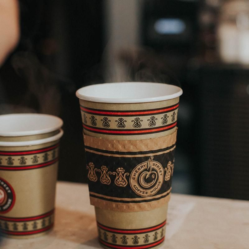 Two cups of coffee are sitting on a table