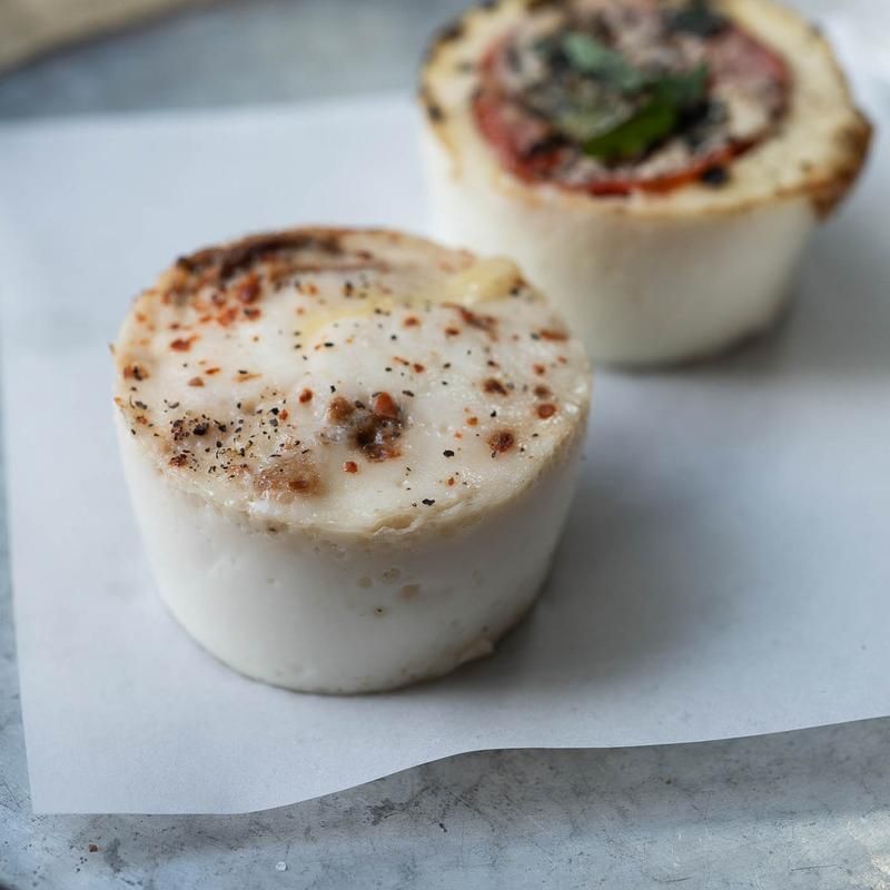 A close up of two pieces of food on a piece of paper