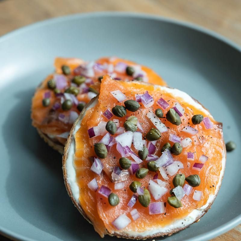 Two slices of smoked salmon with onions and capers on a plate