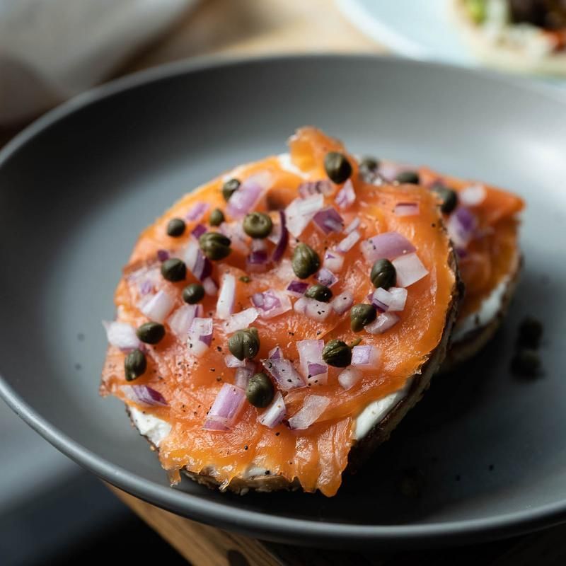 A close up of a plate of Lox & Cream Cheese Bagel on a table