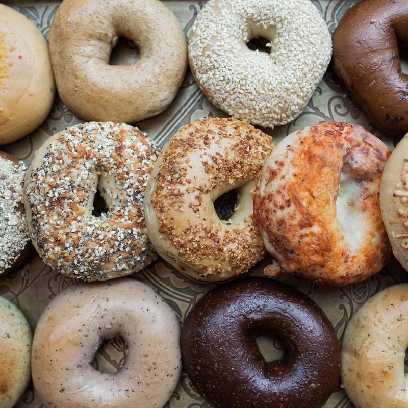 A variety of bagels are sitting on a table.