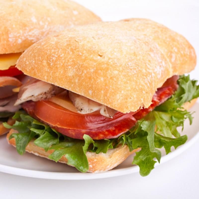 A close up of a sandwich on a white plate