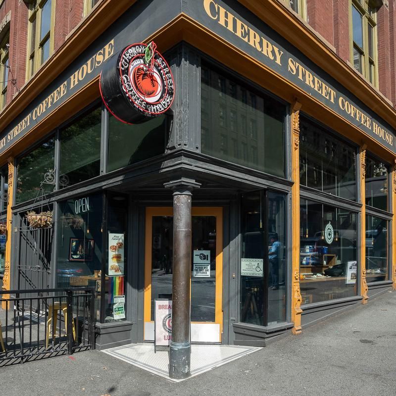 Cherry street coffee house is located on the corner of a building