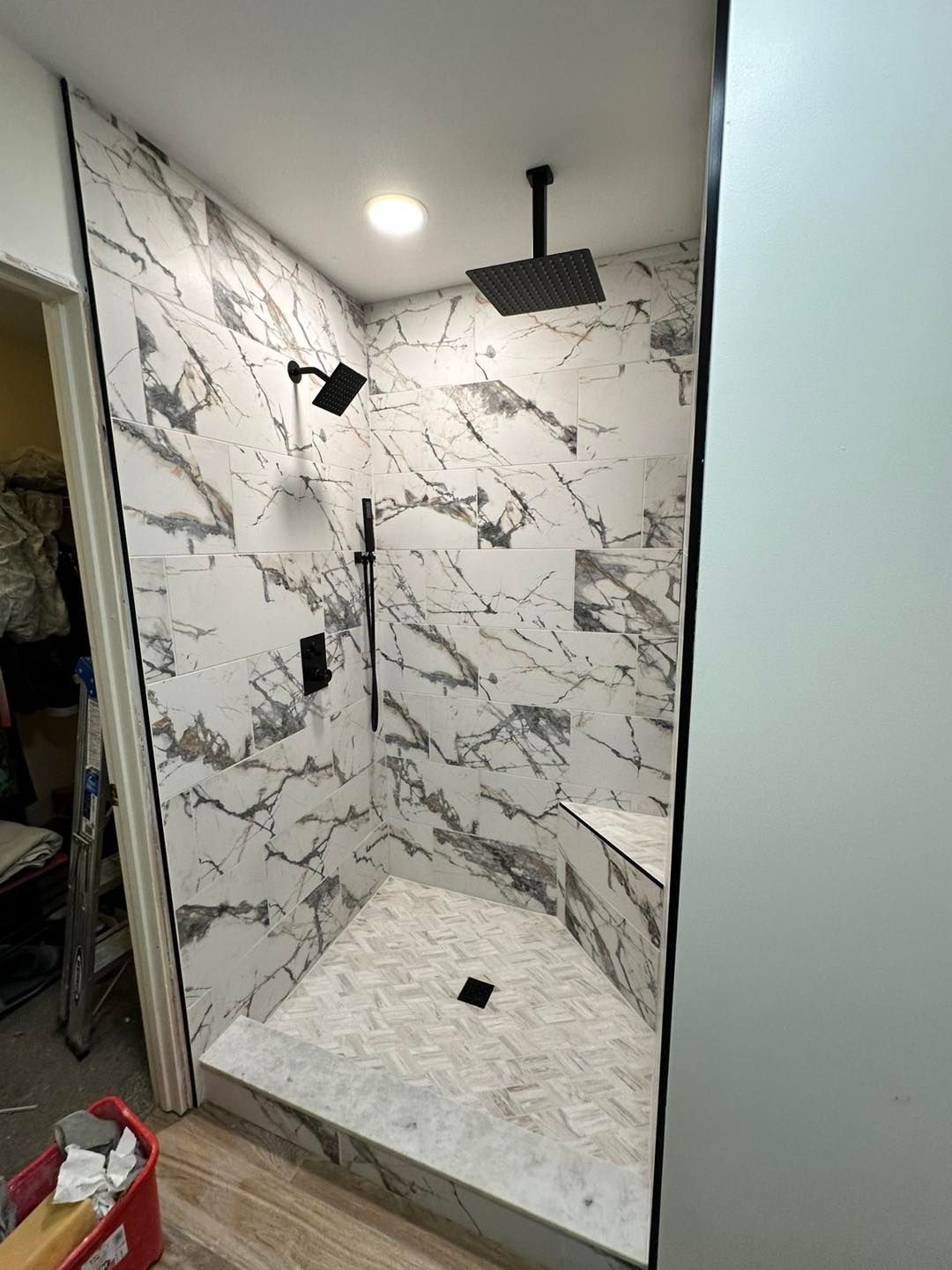 A shower is being remodeled with a lot of tiles on the wall