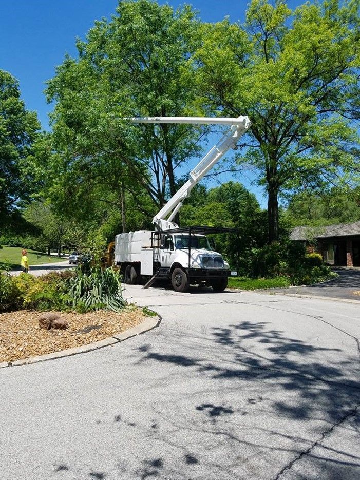 A white truck with a crane on top of it