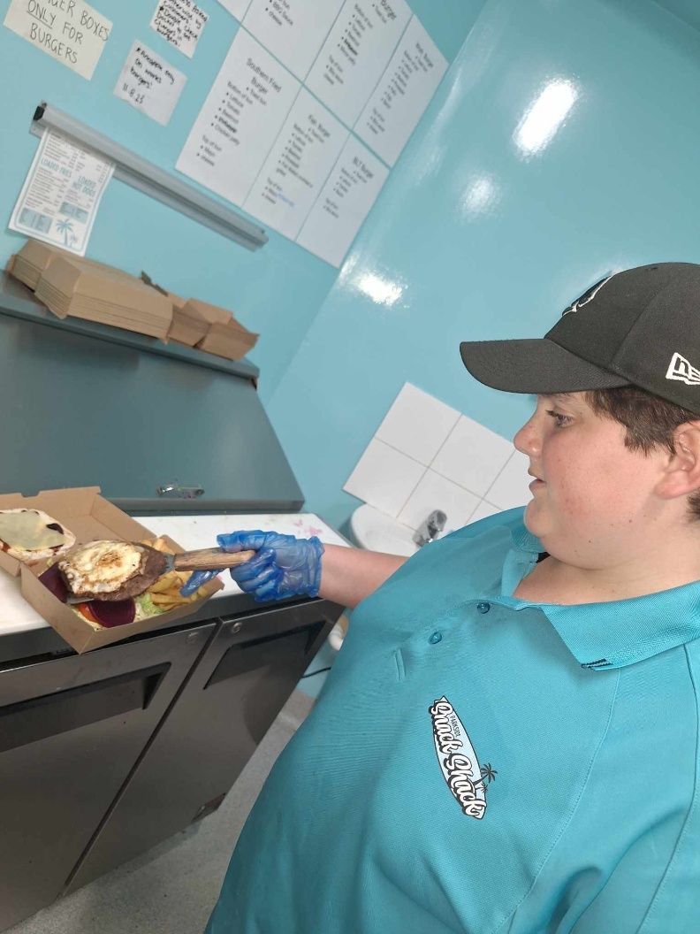 A Boy Cooking A Burger - Parkside Snack Shack in Emu Park