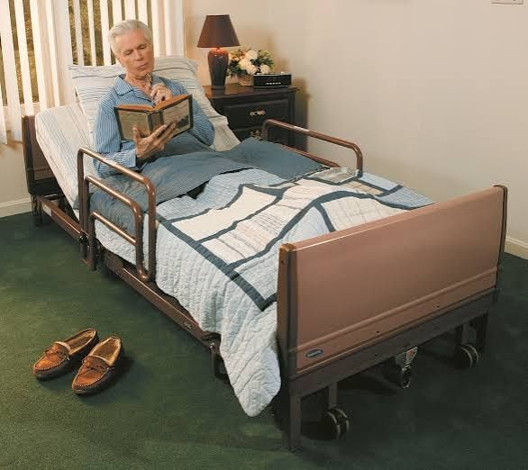 Hospital bed with blue sheets and pillows in a bright, empty room Hospital bed with blue sheets and pillows in a bright, empty room
