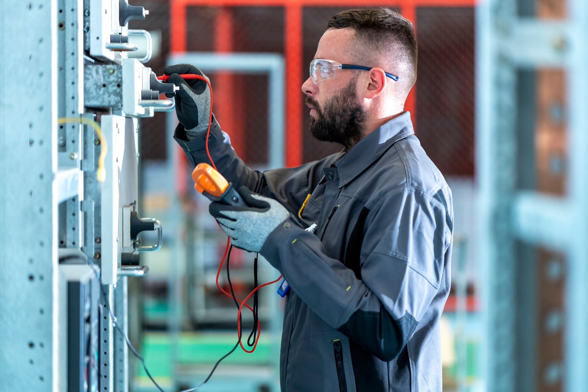 Wind turbines on a hillside, blades turning. A dirt road runs alongside.