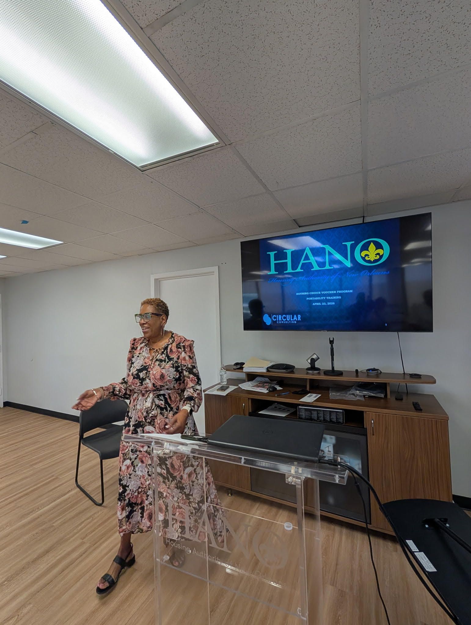 A woman is giving a presentation to a group of people