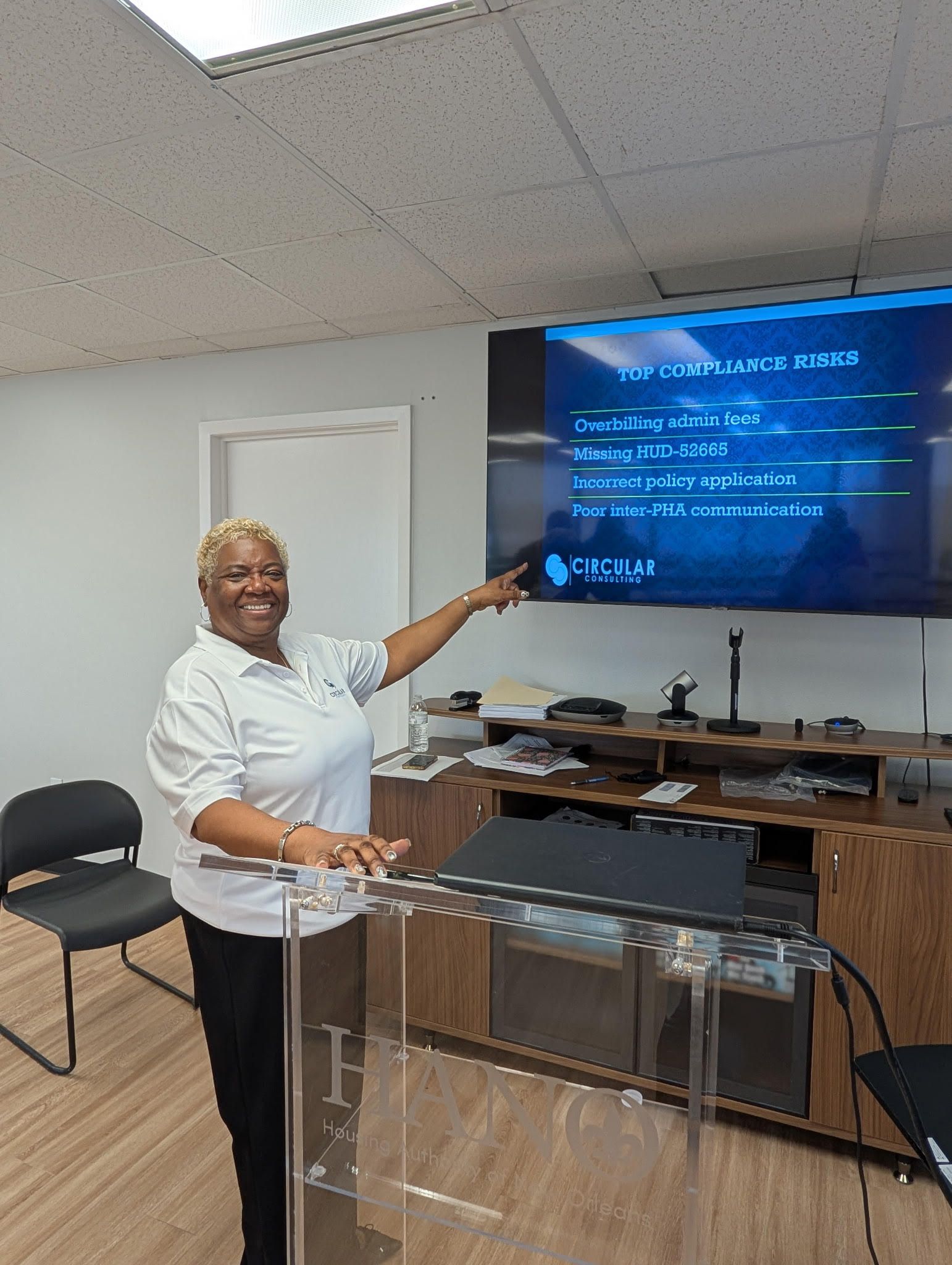 A man is giving a presentation to a group of people sitting at tables.