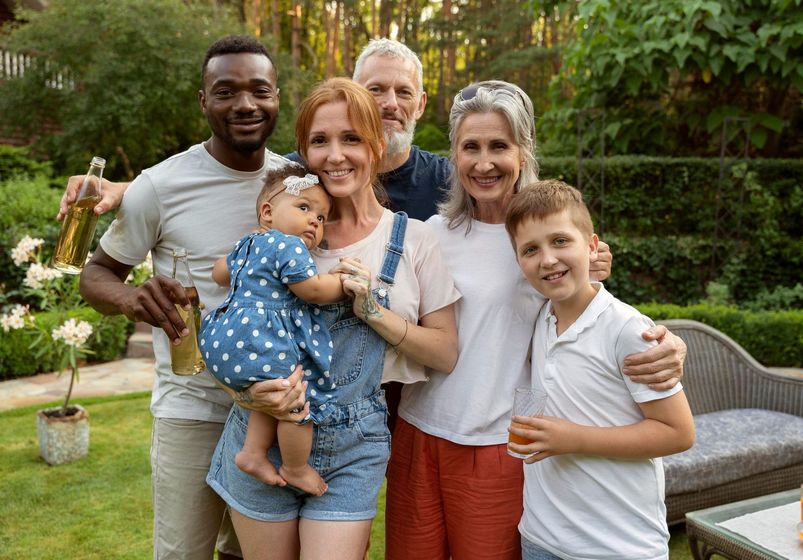 A group of people are posing for a picture in a garden.