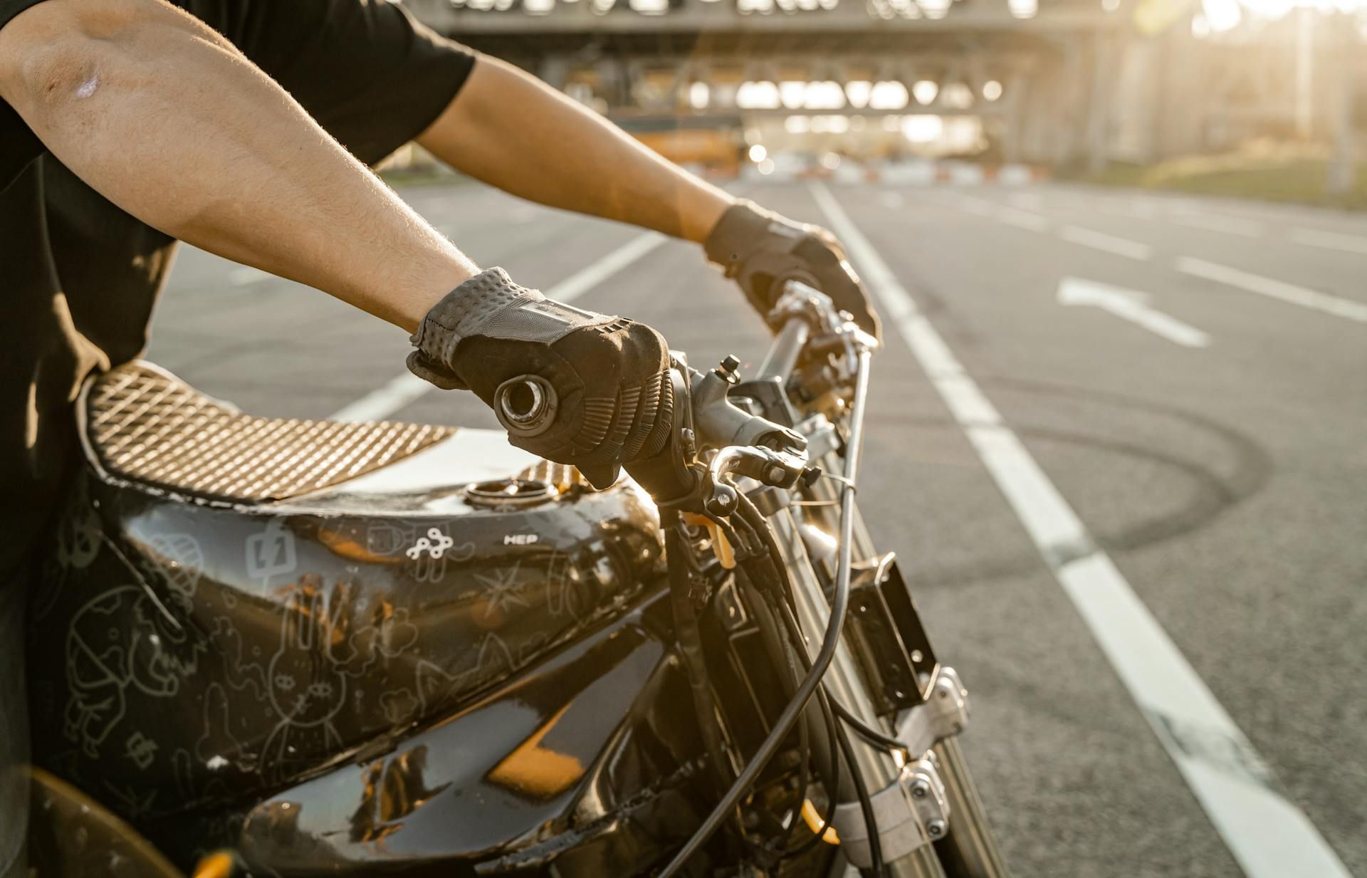 A man is riding a motorcycle down a road.