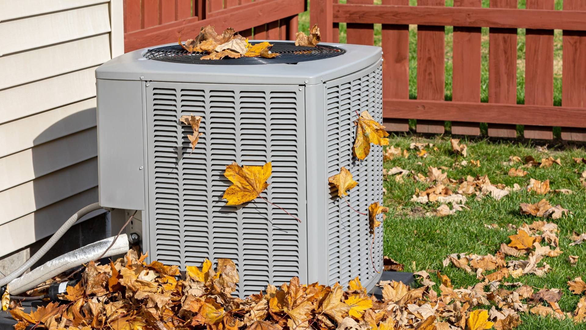 Residential HVAC Inside a Fenced Yard Surrounded by Fall Leaves near Lexington, Kentucky