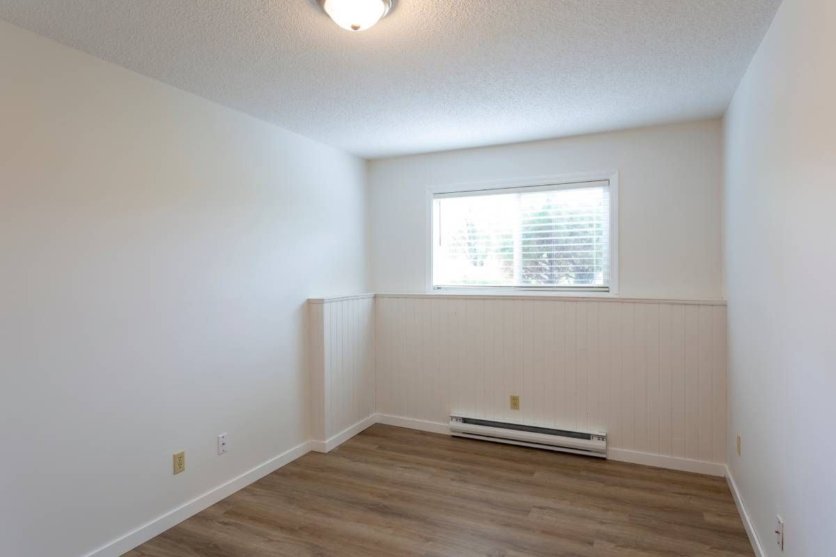 A baseboard heater in a white, empty room with a small, horizontal window at Advantage Air HVAC near Lexington, Kentucky (KY)