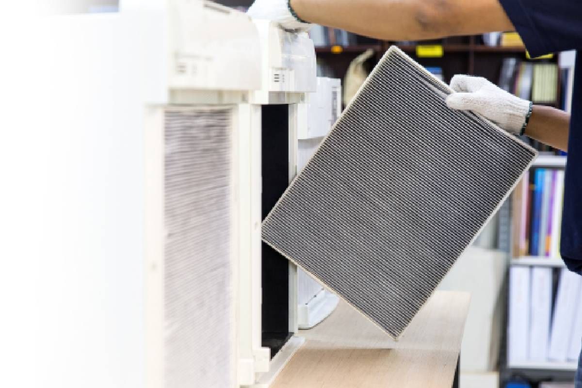 Man removing a filter from an HVAC system at Advantage Air HVAC near Lexington, Kentucky