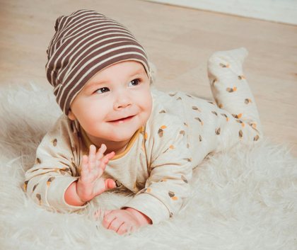Older woman smiles while holding hands with another woman outdoors.