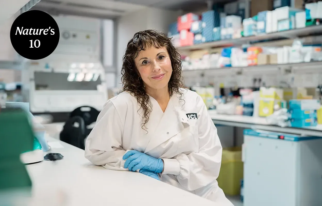 Women in lab coat and latex gloves in a laboratory.