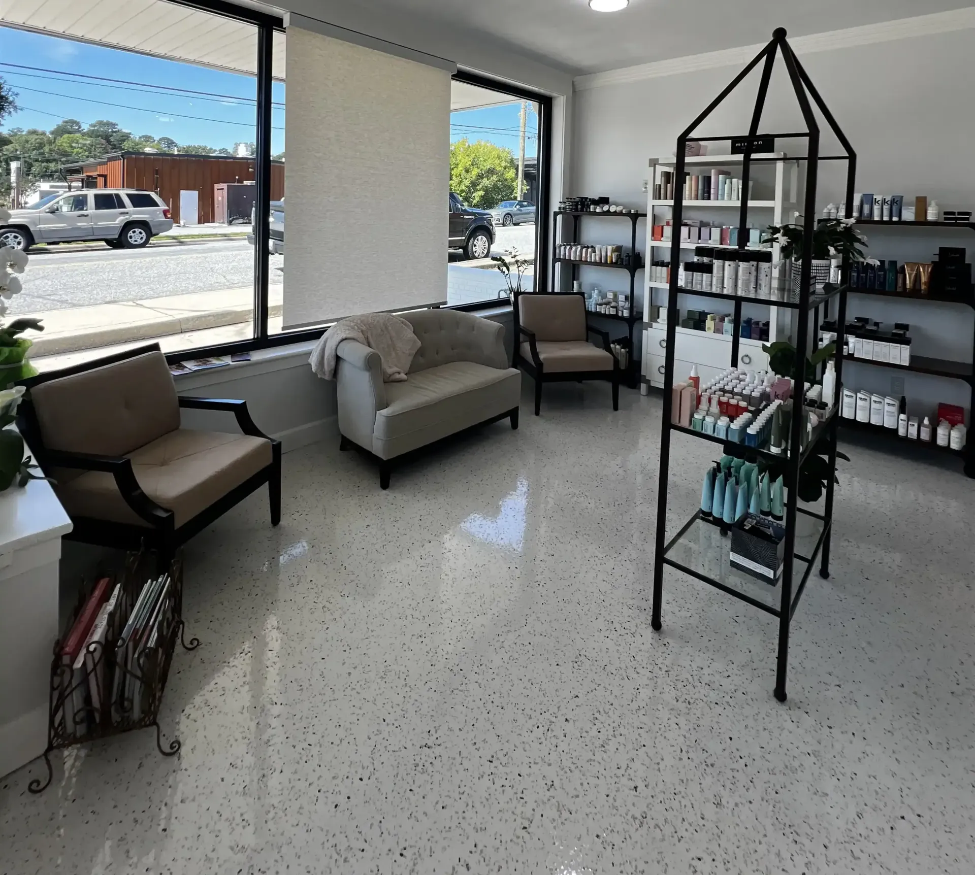Evolve Master Salon's waiting room with a couch and two chairs