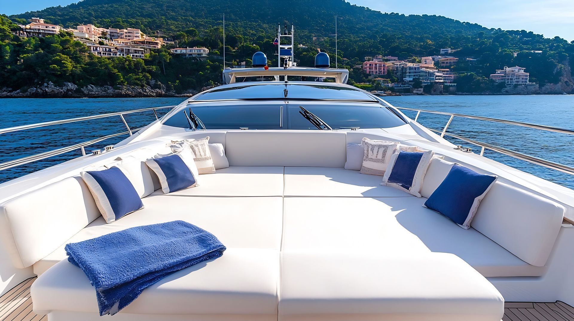 The front of a yacht with a couch and pillows on it.