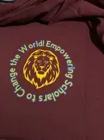 Maroon shirt with circular logo: lion head, text reads 