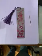 Bookmark with purple tassel; text reads 