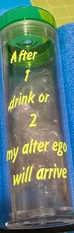 A clear container with a green lid has text in yellow: 