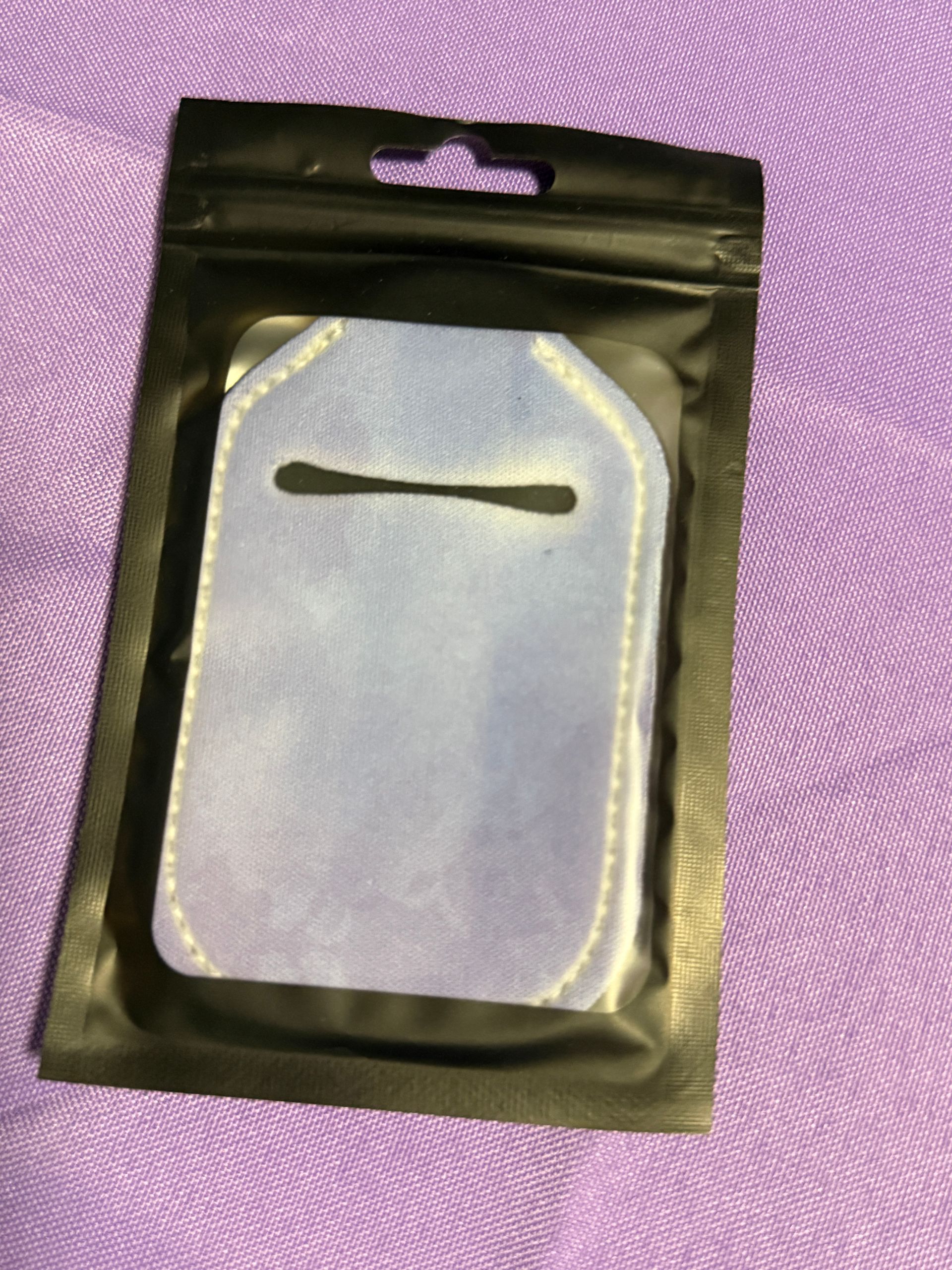 Blue hand sanitizer keychain with a bottle of sanitizer