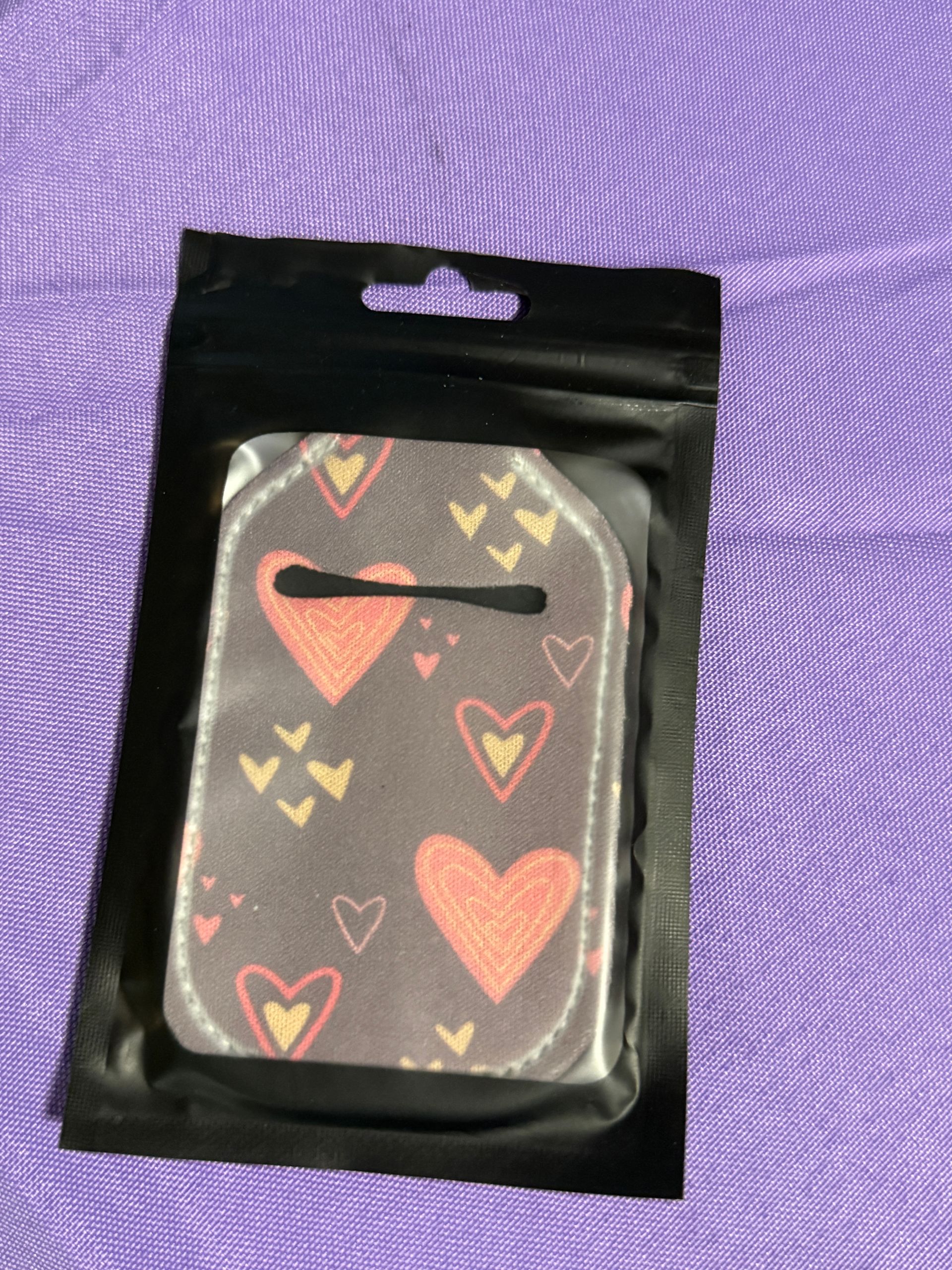 Brown with red and yellow hearts, hand sanitizer keychain with a bottle of sanitizer