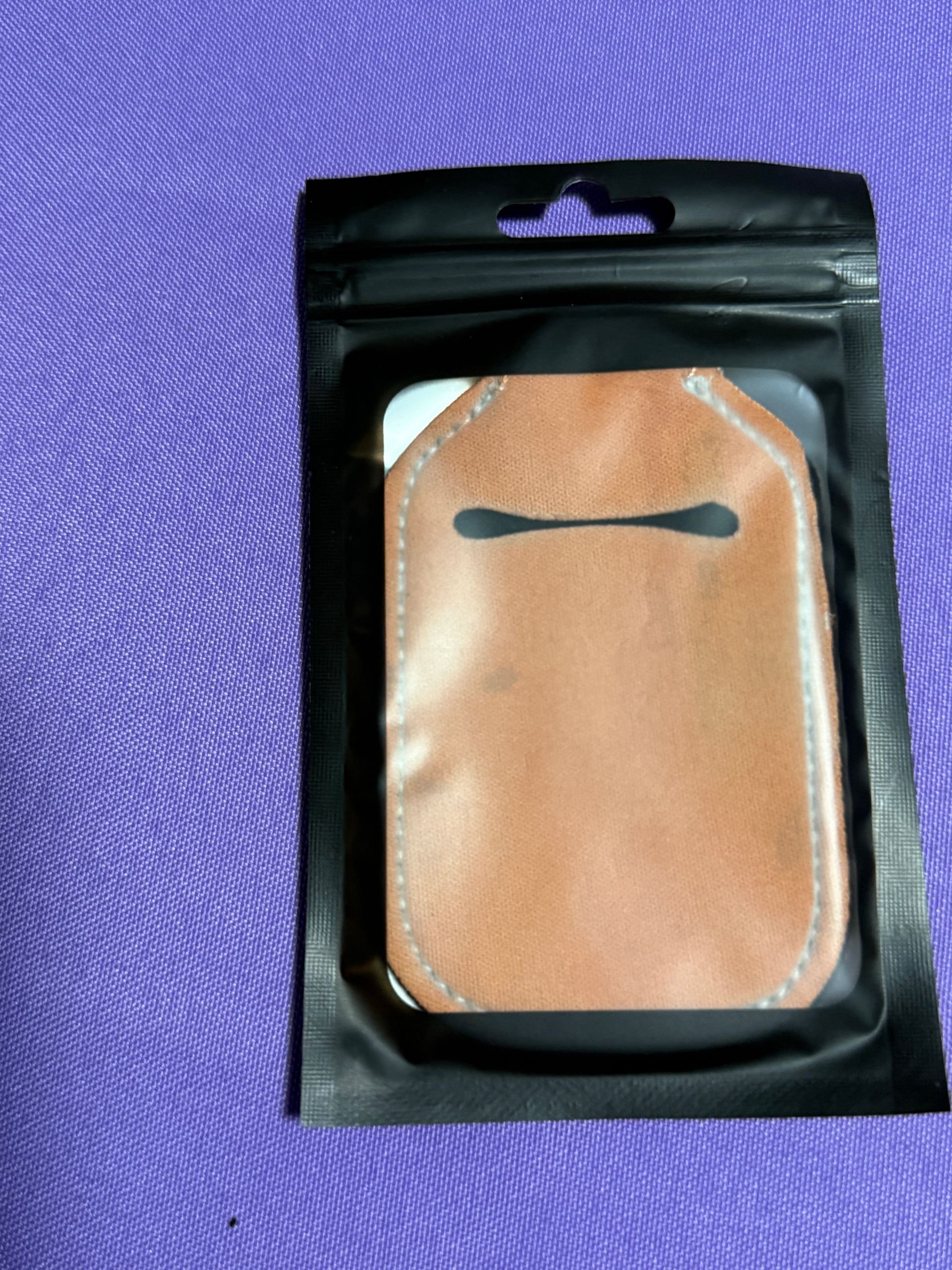 Orange hand sanitizer keychain with a bottle of sanitizer