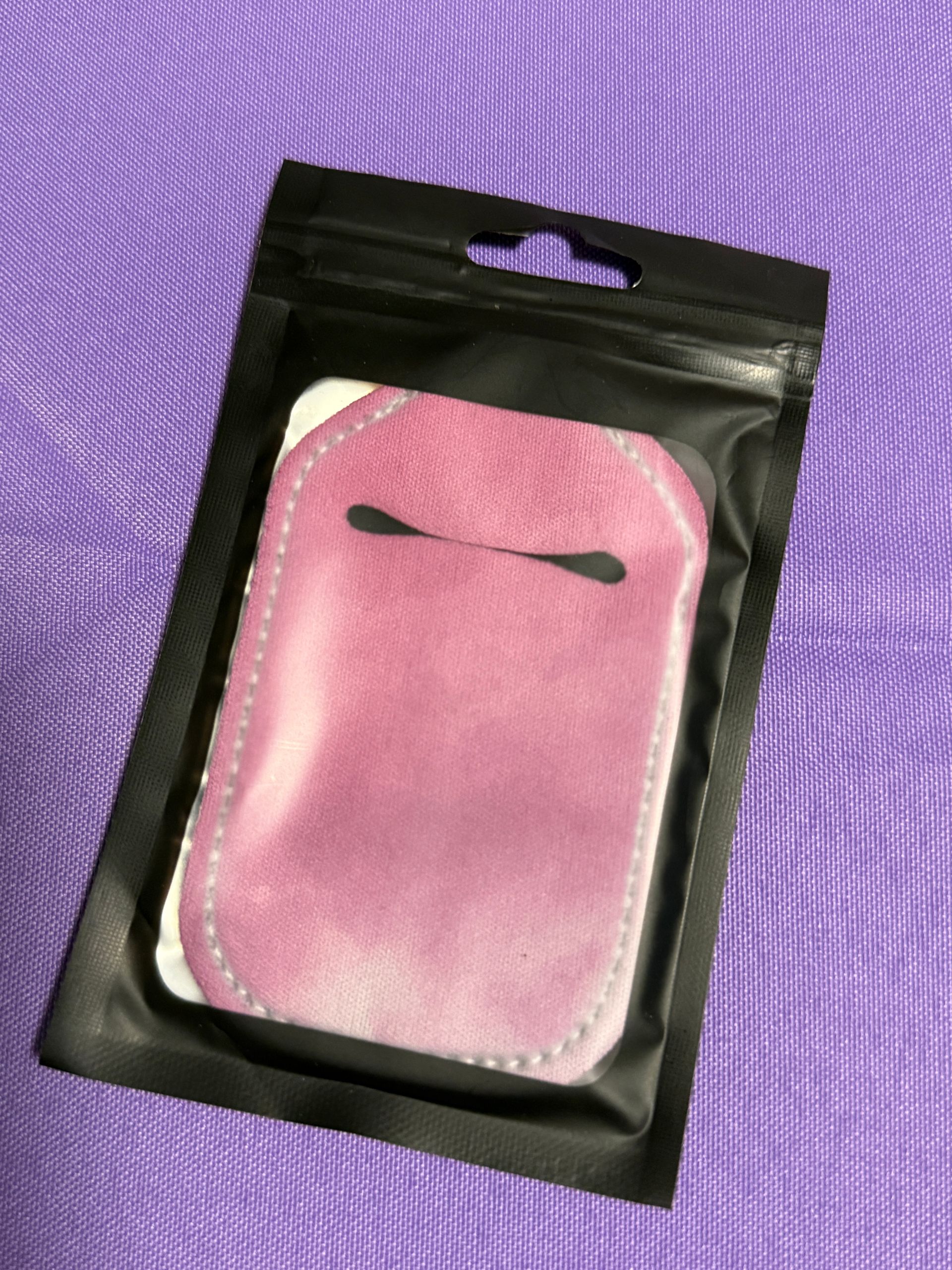 pink hand sanitizer keychain with a bottle of sanitizer