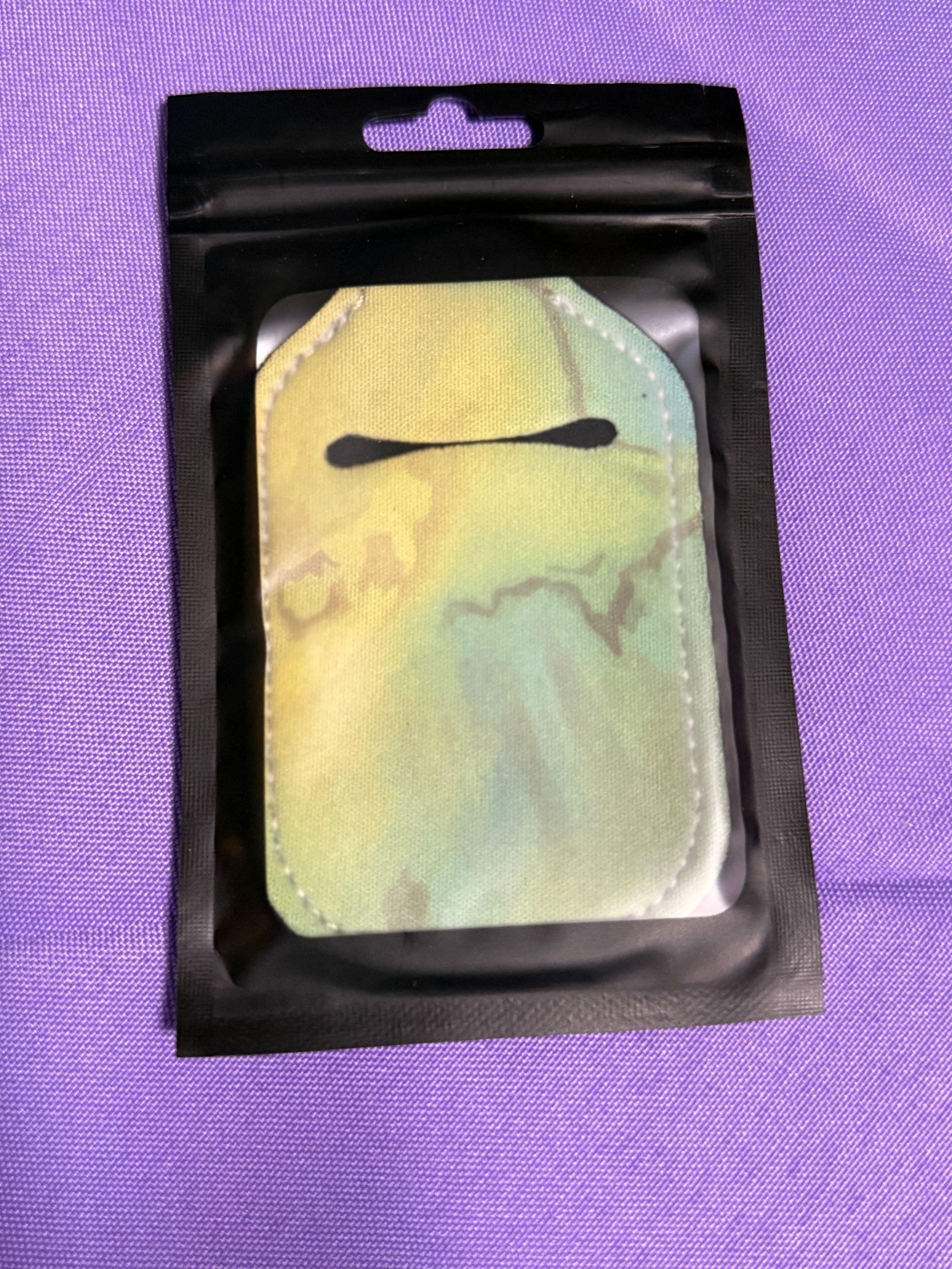 yellow and green hand sanitizer keychain with a bottle of sanitizer