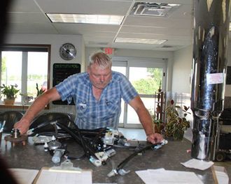 Man Looking At Some Auto Parts — Ellendale, MN — Misgen Auto Parts