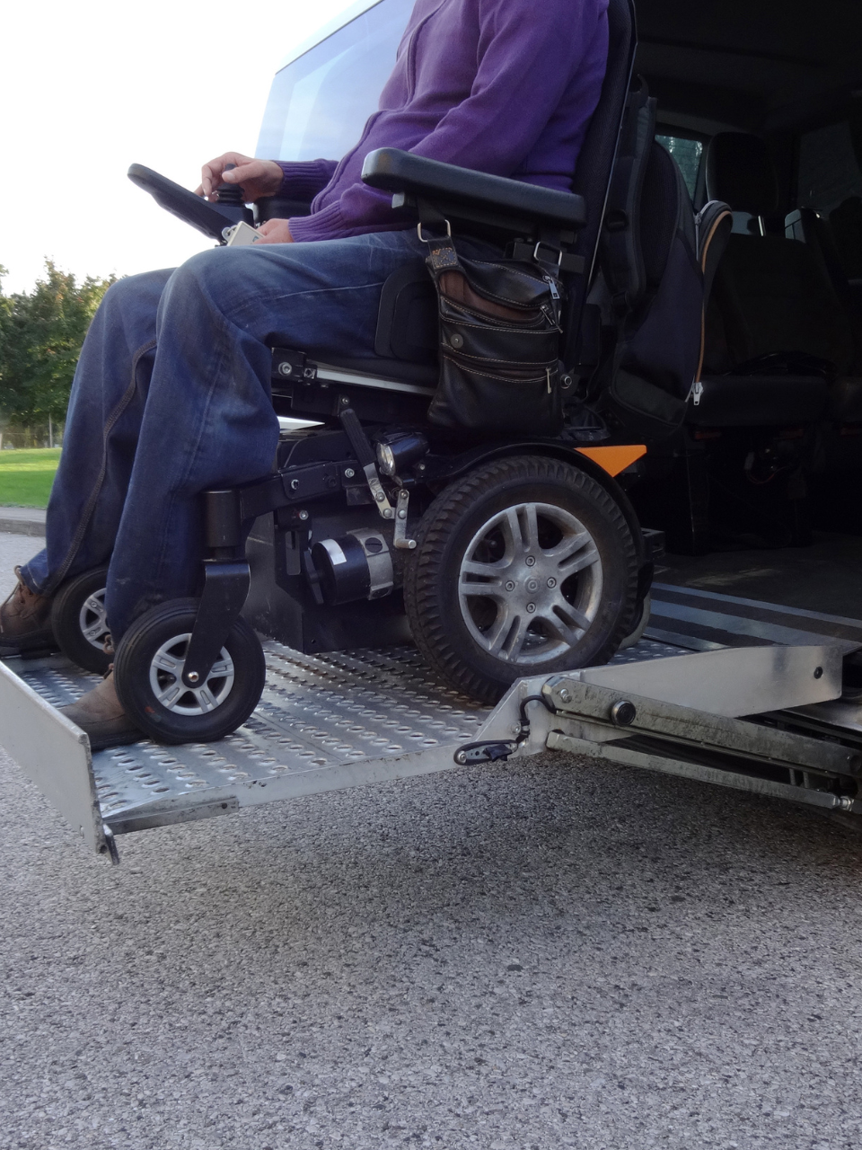 Woman pouring drink for older man at table; breakfast setting.