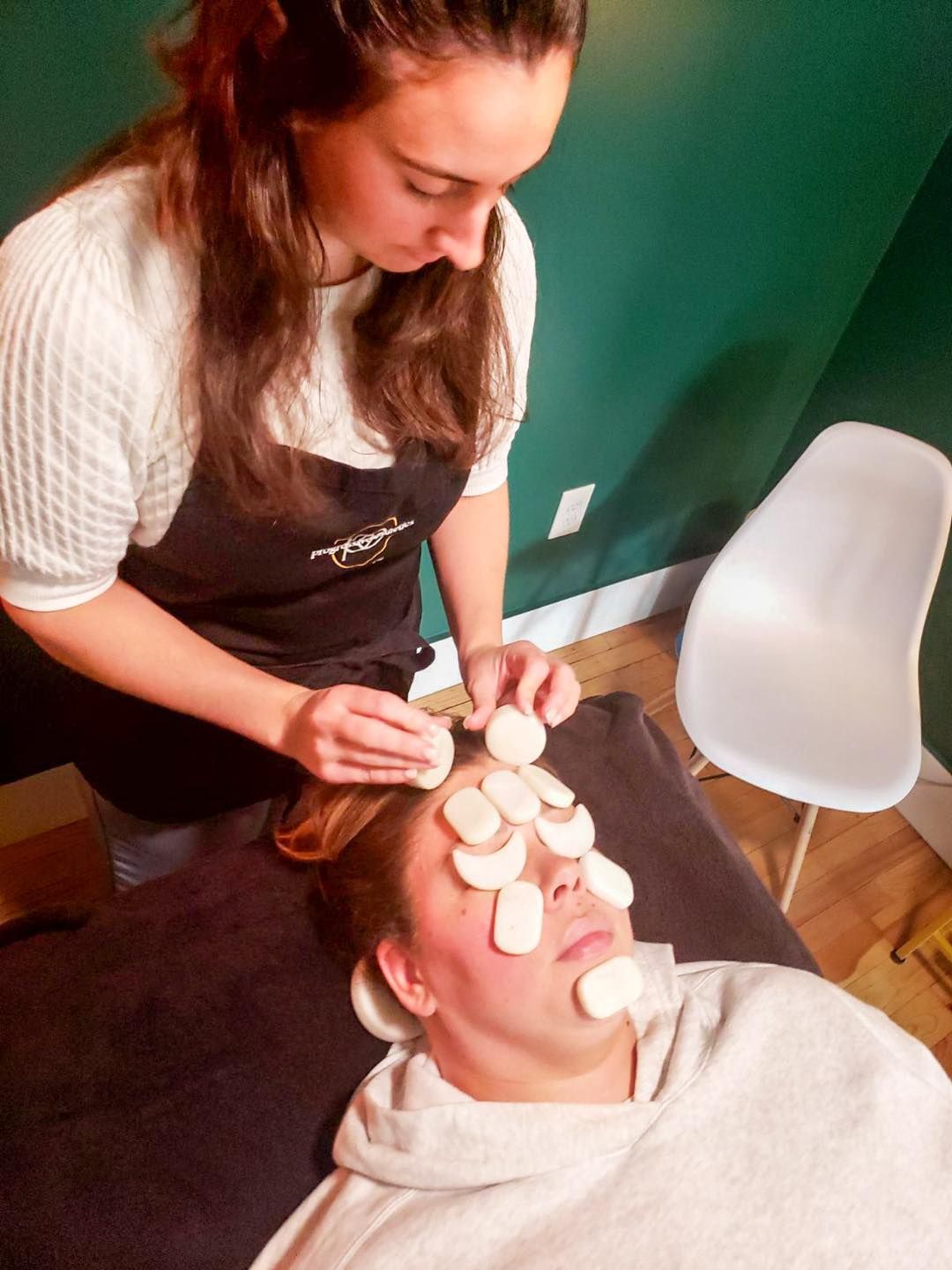 Hairdresser applying color to hair on a wooden board, foil wrapped around sections, salon setting.