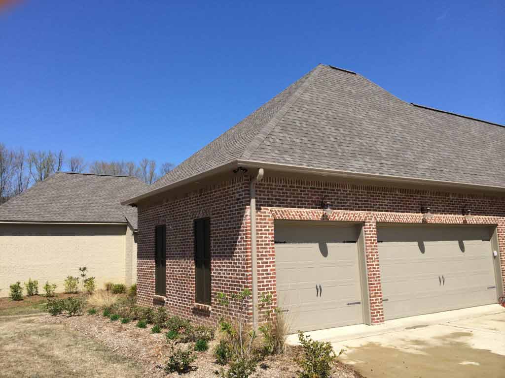 Seamless Gutter Installation — Brick House with 2 Garage Doors in Madison, MS