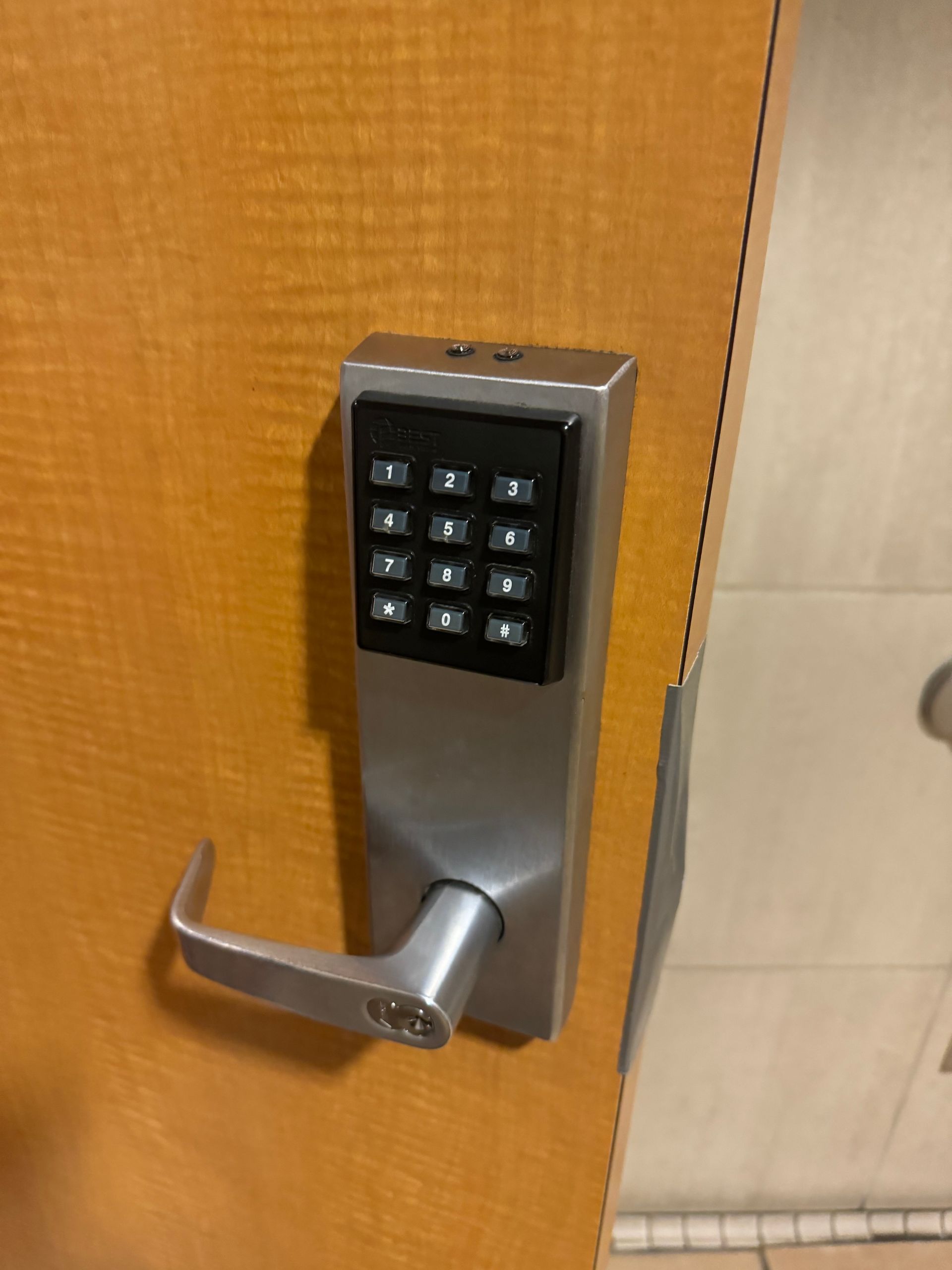 A close up of a door with a keypad on it.